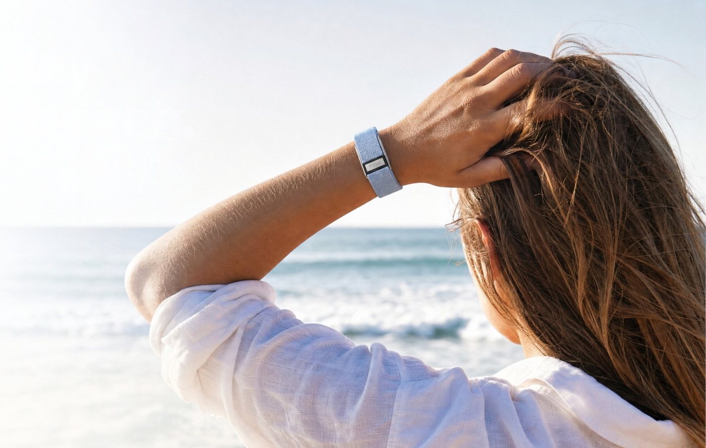 Woman at the beach wearing a Thrive band