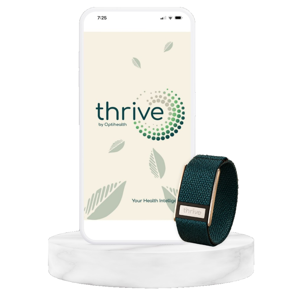 The Thrive Band in Daintree on a marble stand beside a phone showing the Thrive app