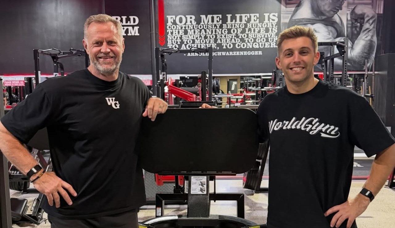 World Gym founder Mike Nysten and Anton De Pasquale in a World Gym club, both wearing Thrive bands